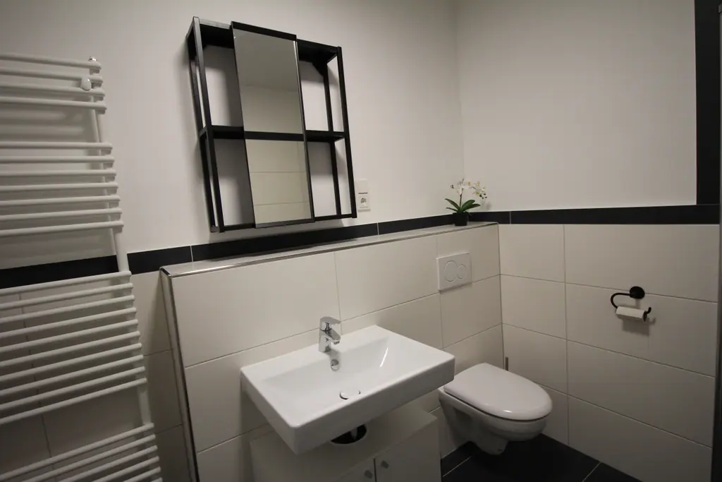 Bad mit Waschbecken und Handtuchheizung